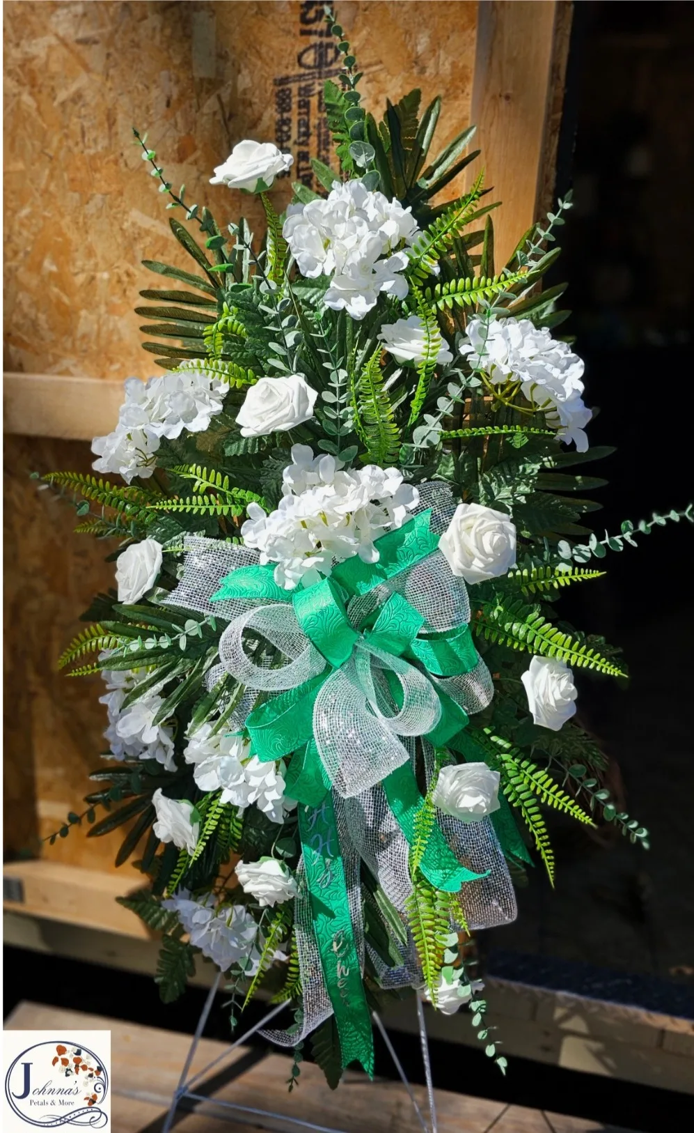 Silk white and green themed spray on easel Silk white and green themed spray on easel