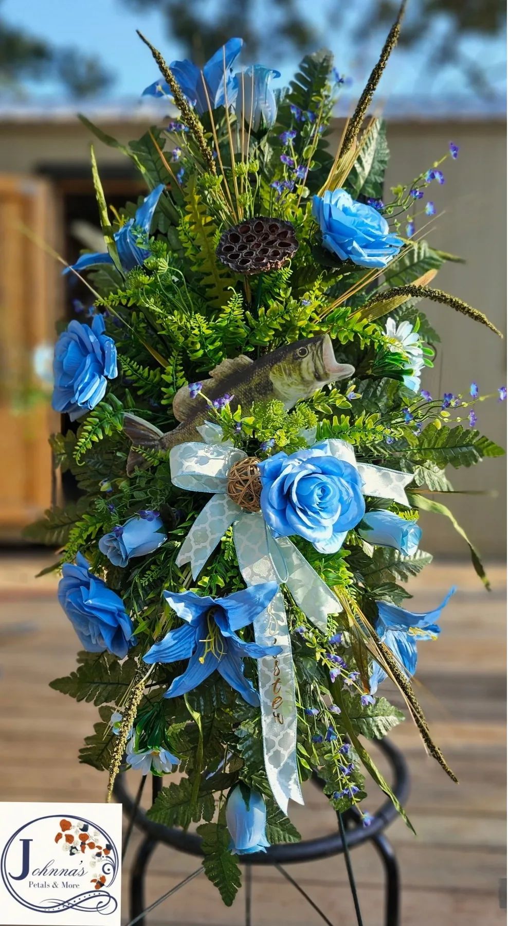 Bass and the color Blue Silk spray on easel with bass and variety of blue themed flowers