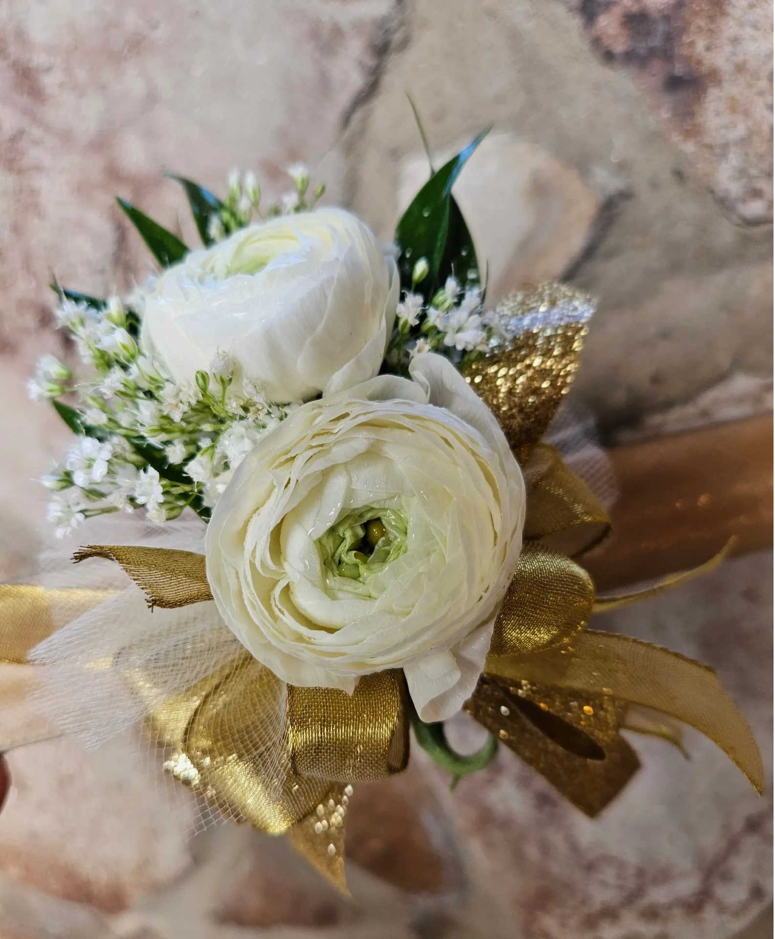White and gold with ranunculus wrist corsage White and gold with ranunculus wrist corsage